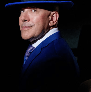 Jeff Flaster in blue suit and hat.